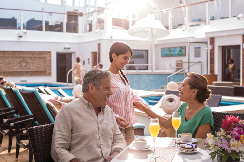 A Group Meets on the Deck by the Pool for Mimosas at The Haven by Norwegian